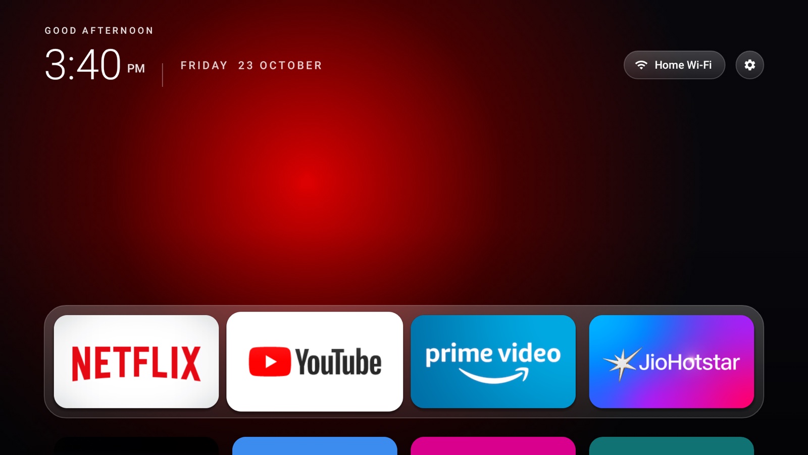 Jisha home screen in Night mode: clock, date, Wi-Fi and Settings buttons, and a glass dock with Netflix, YouTube, Prime Video and JioHotstar over a red glow.